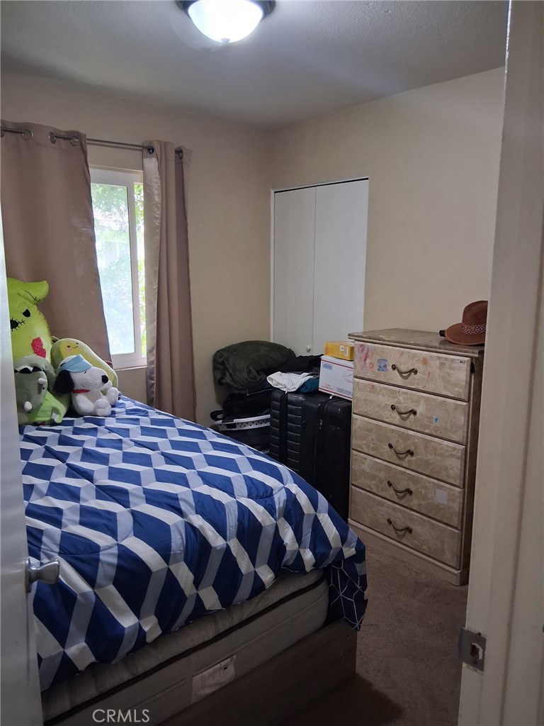 1777 Mitchell Avenue, Unit 29 Tustin, CA 92780 - Photo 10 of 26 a bedroom with a bed and a window