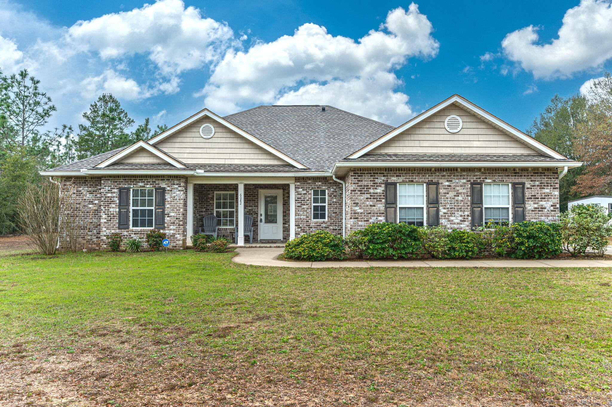 6082 Robin Road Crestview, FL 32539 - Photo 1 of 45 a front view of a house with garden