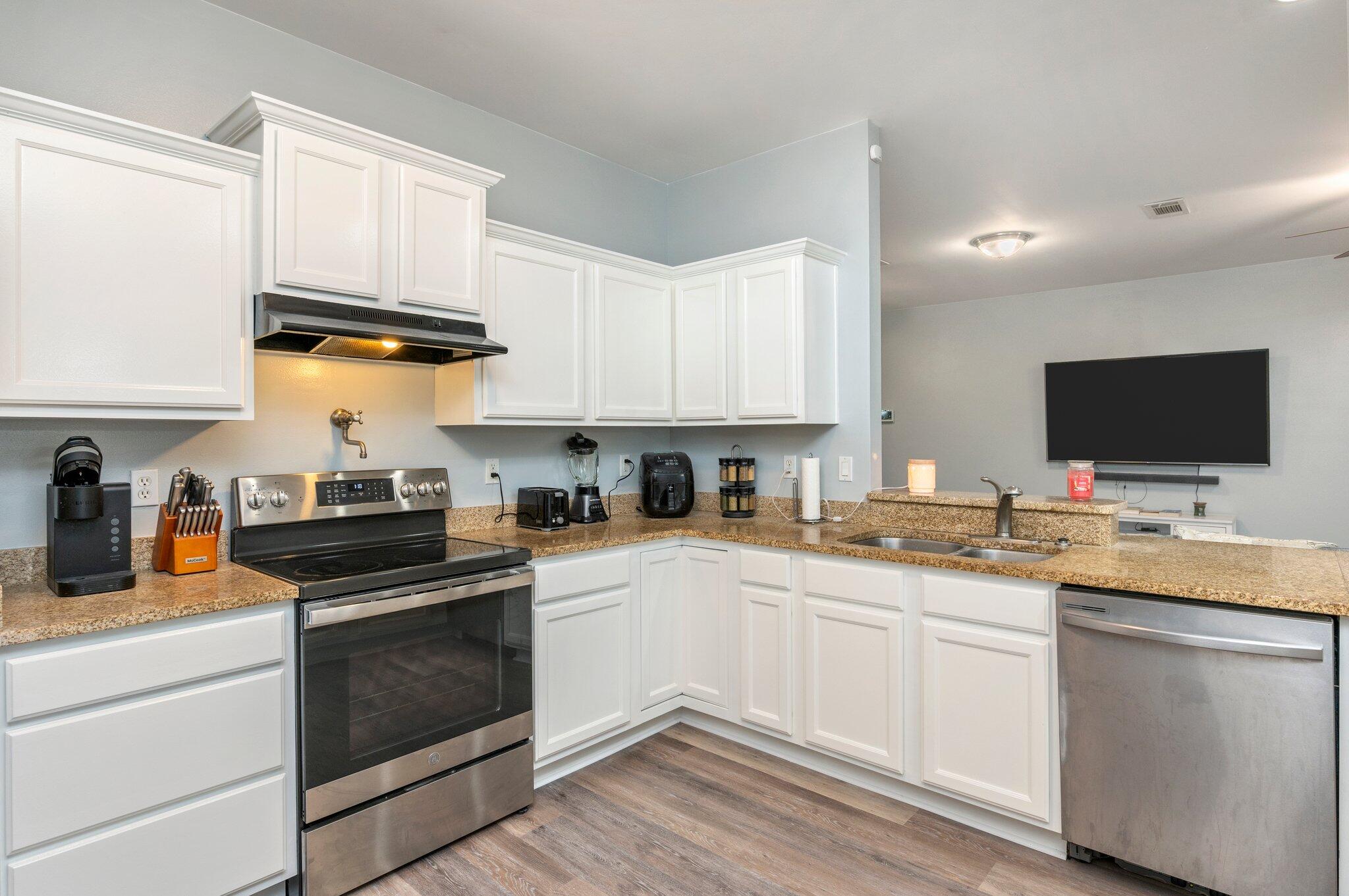 6082 Robin Road Crestview, FL 32539 - Photo 13 of 45 a kitchen with stainless steel appliances granite countertop a sink and cabinets