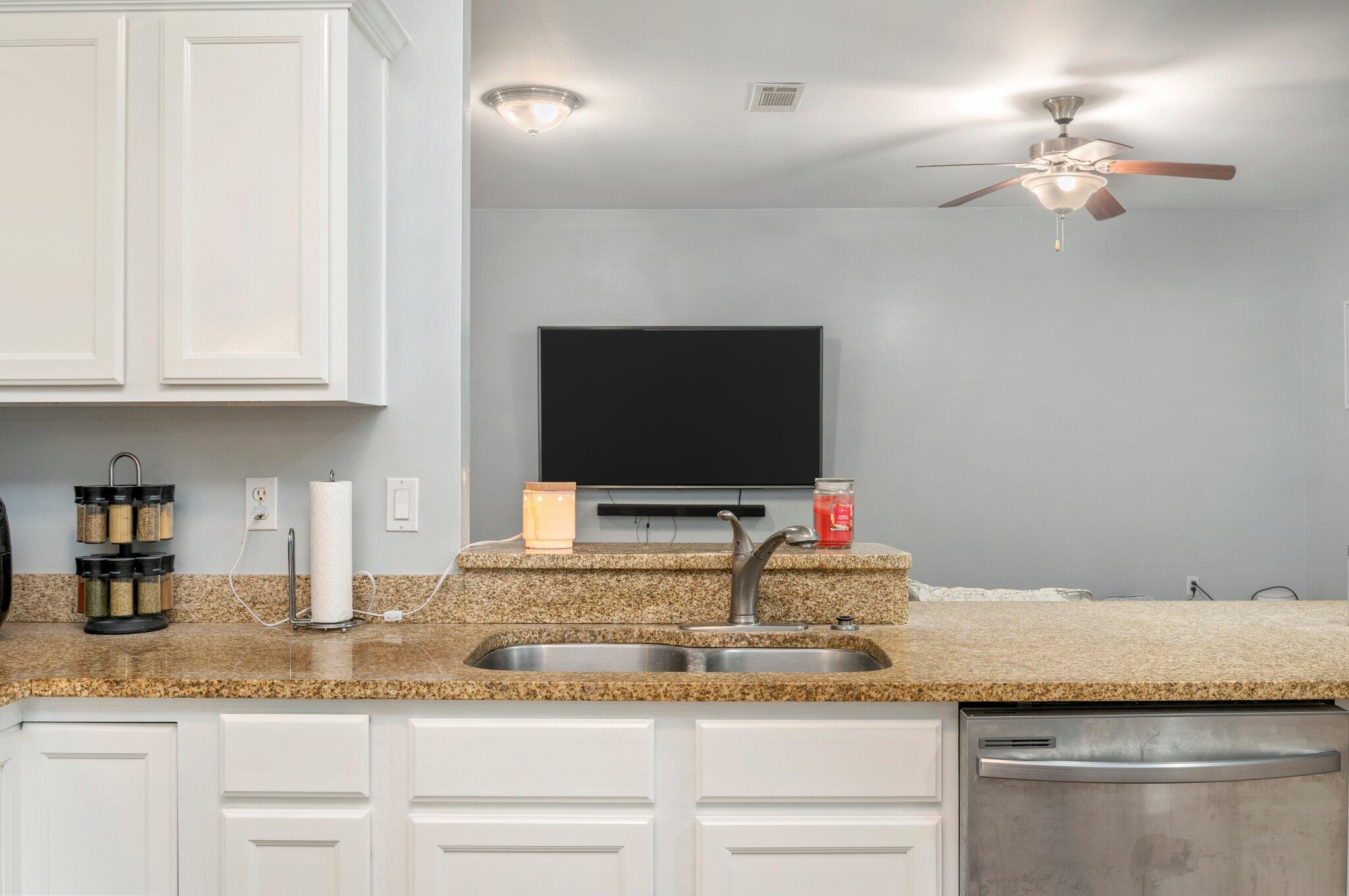 6082 Robin Road Crestview, FL 32539 - Photo 14 of 45 a kitchen with granite countertop a sink and cabinets