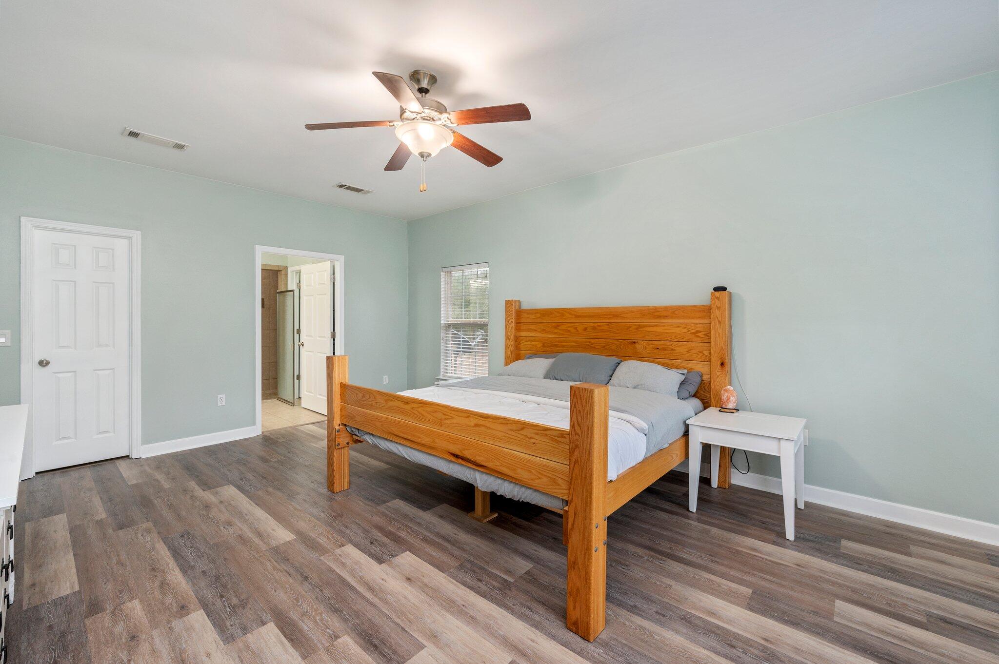 6082 Robin Road Crestview, FL 32539 - Photo 20 of 45 a bedroom with a bed and wooden floor