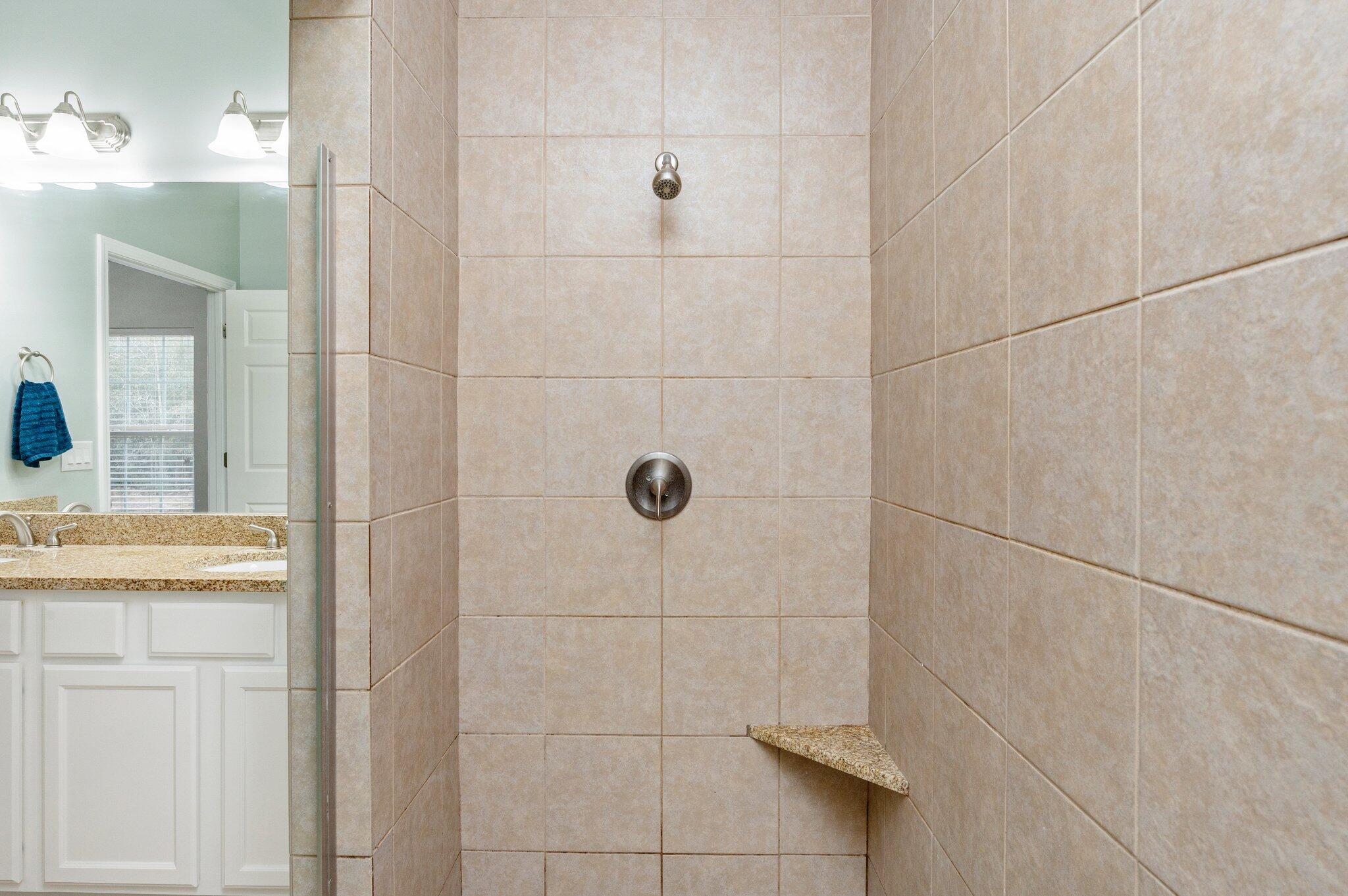 6082 Robin Road Crestview, FL 32539 - Photo 24 of 45 a bathroom with a granite countertop shower a sink and vanity
