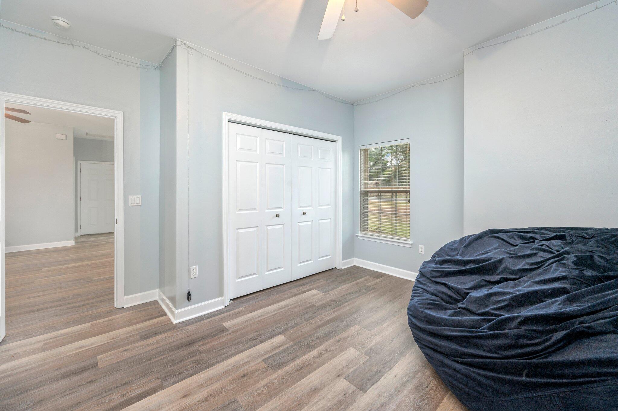 6082 Robin Road Crestview, FL 32539 - Photo 27 of 45 a bedroom with a bed and wooden floor