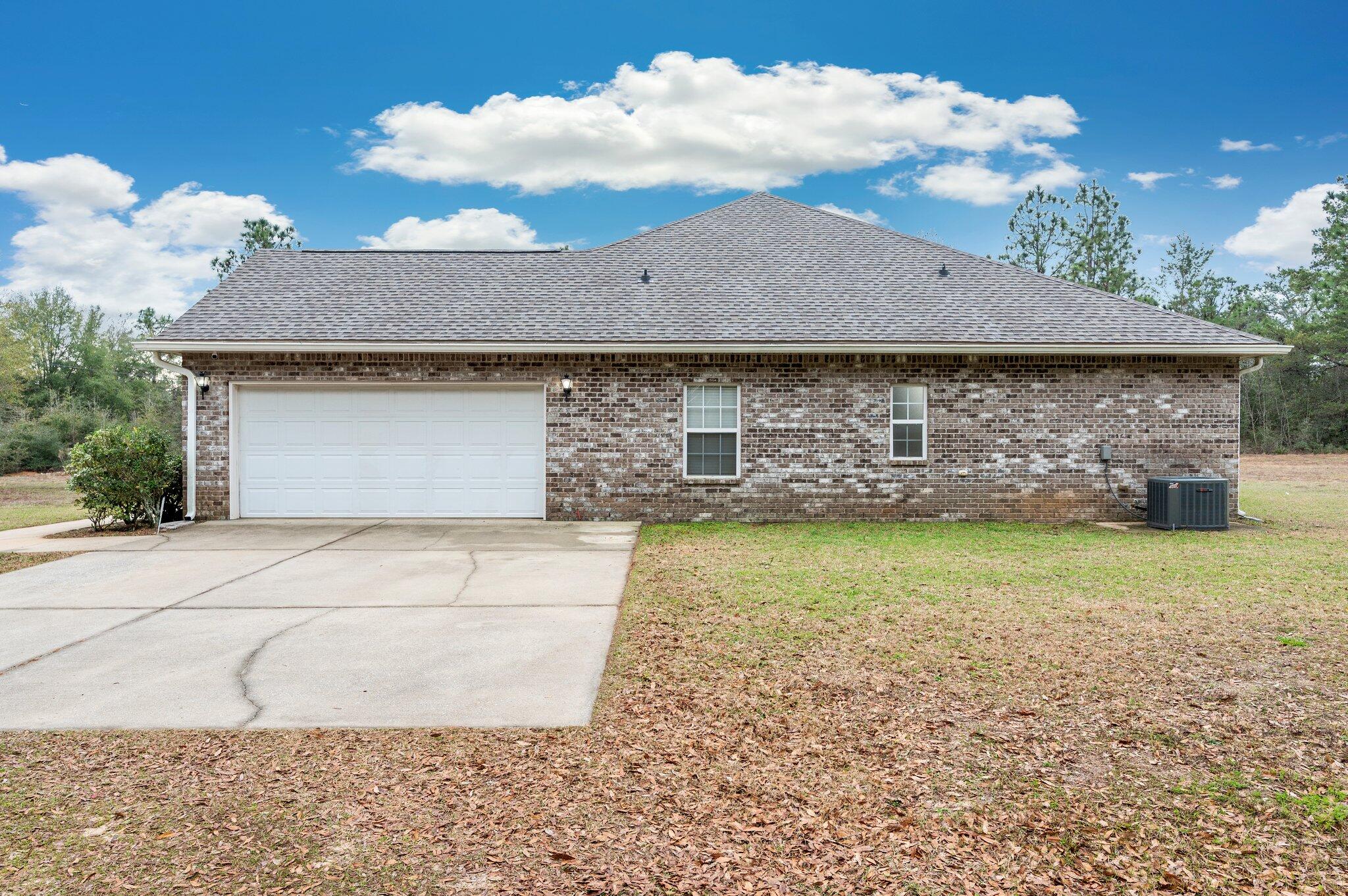 6082 Robin Road Crestview, FL 32539 - Photo 41 of 45 a front view of a house with garden