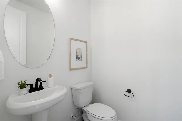 a white toilet sitting next to a bathroom sink