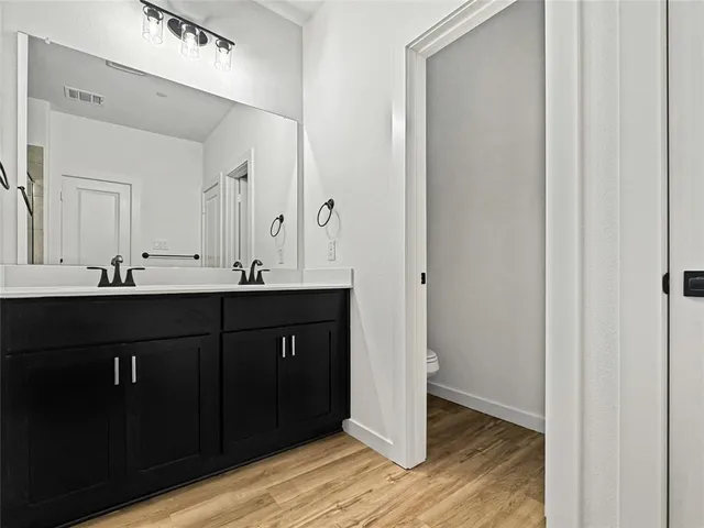 a bathroom with a double vanity sink and mirror