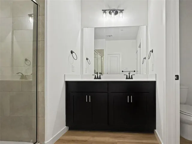 a bathroom with a sink vanity and a mirror