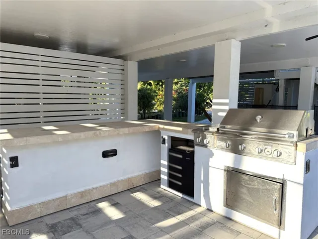 a view of a patio with a table chairs and a backyard