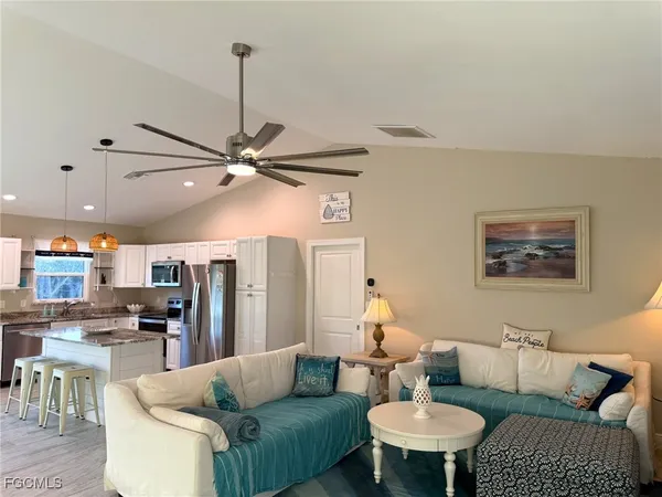 a living room with furniture and kitchen view