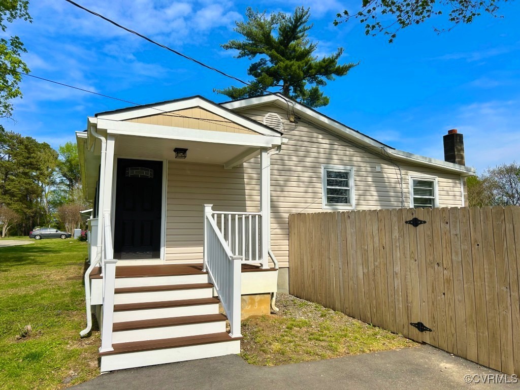 2721 Perlock Road Richmond, VA 23237 - Photo 26 of 27 Bungalow-style house with a chimney, fence, and a