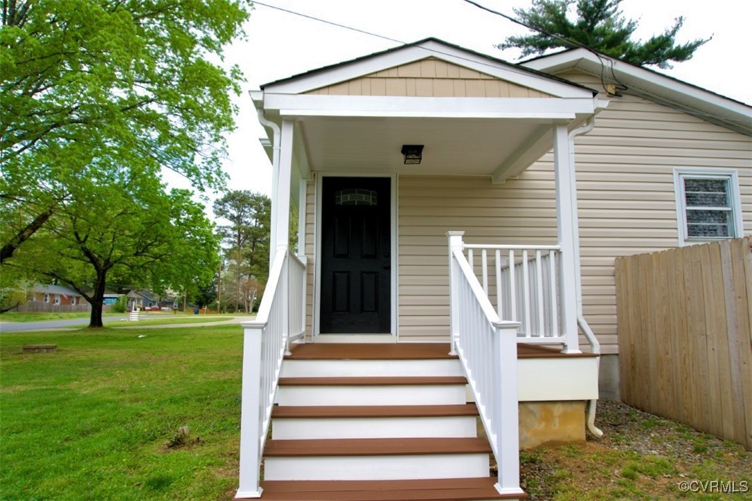 2721 Perlock Road Richmond, VA 23237 - Photo 3 of 27 View of exterior entry with fence and a lawn