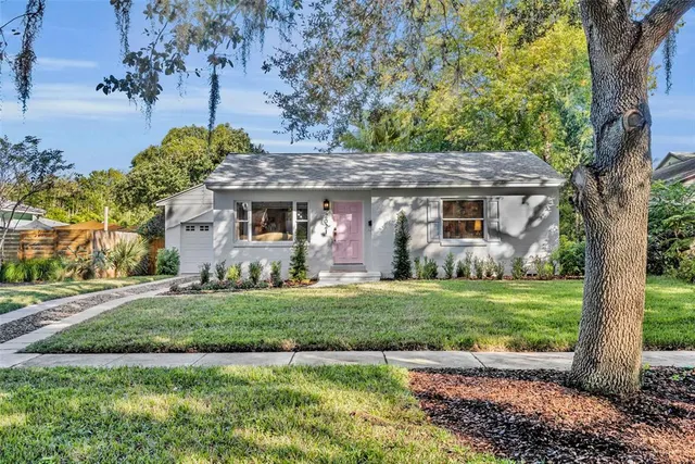 a front view of a house with a garden