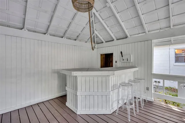 an aerial view of residential house with outdoor space and trees all around