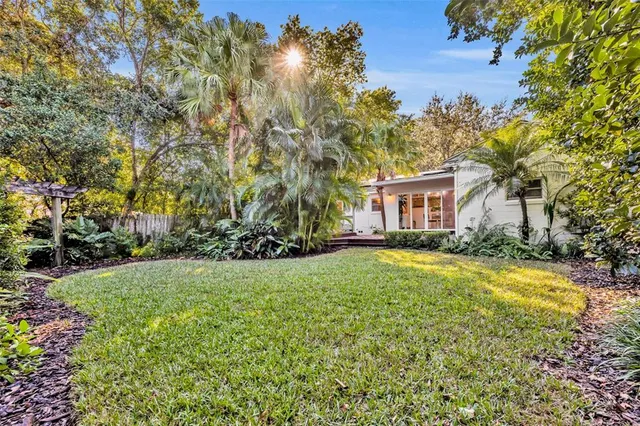 an aerial view of residential house with outdoor space and trees