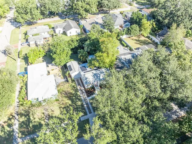 an aerial view of residential houses with city view