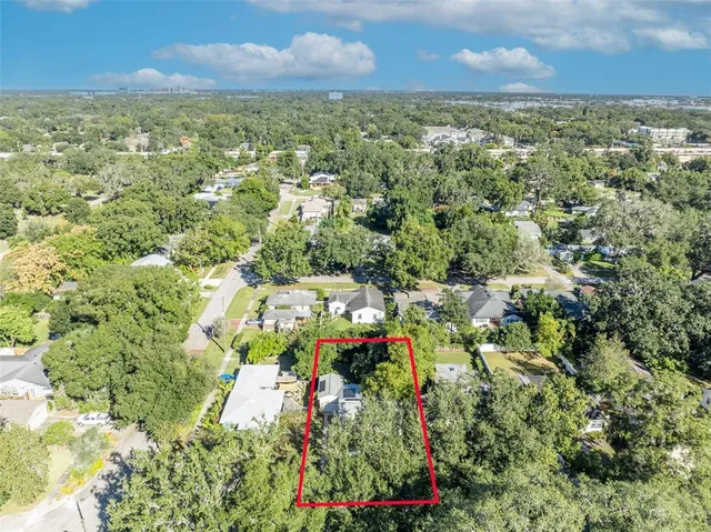an aerial view of a houses with a yard
