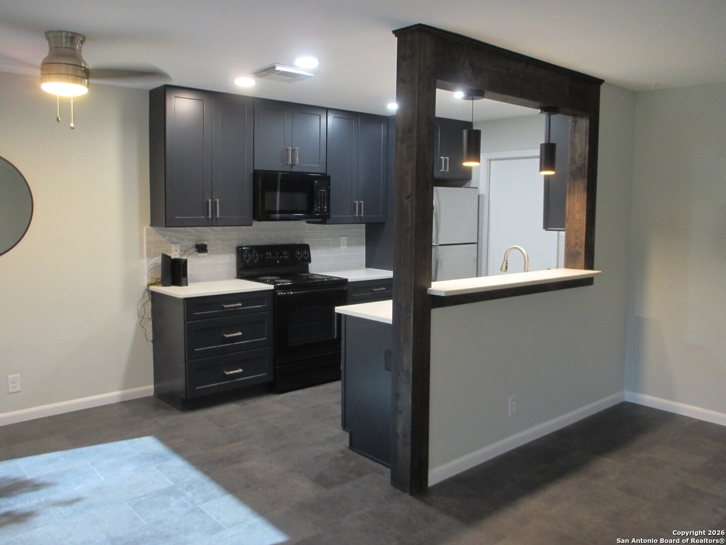 7126 Spring Flower Street San Antonio, TX 78249 - Photo 4 of 20 a kitchen with stainless steel appliances granite countertop a refrigerator and a stove