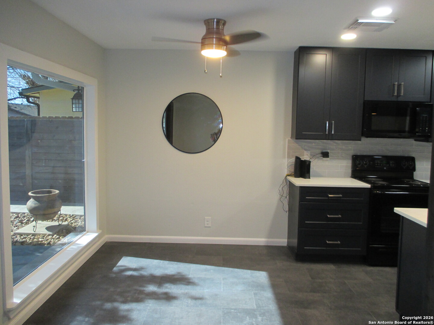 7126 Spring Flower Street San Antonio, TX 78249 - Photo 6 of 20 a kitchen with a sink a stove and cabinets