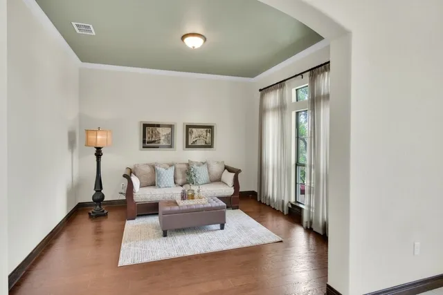 a living room with furniture and a wooden floor