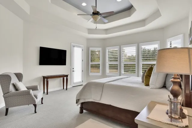 a bedroom with a bed a flat screen tv and a couch