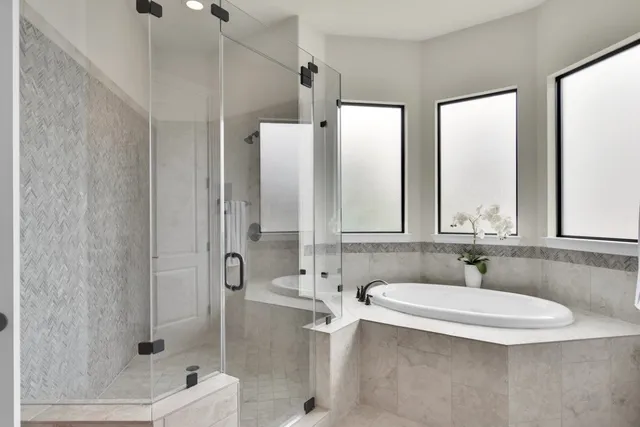 a bathroom with a tub sink and mirror