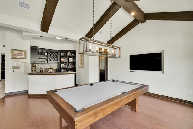 a living room with a table and a flat screen tv