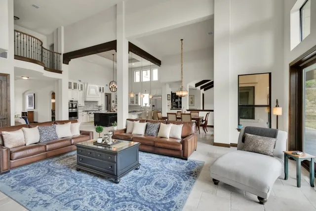a living room with fireplace furniture and a rug