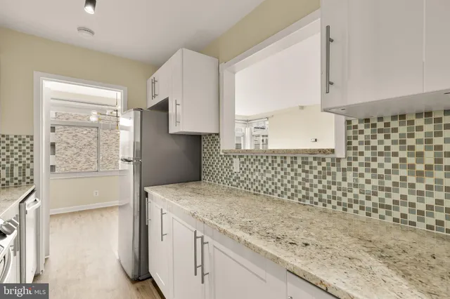 a kitchen with a sink a stove and a refrigerator