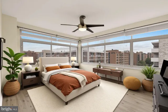 a bedroom with a large bed and a potted plant