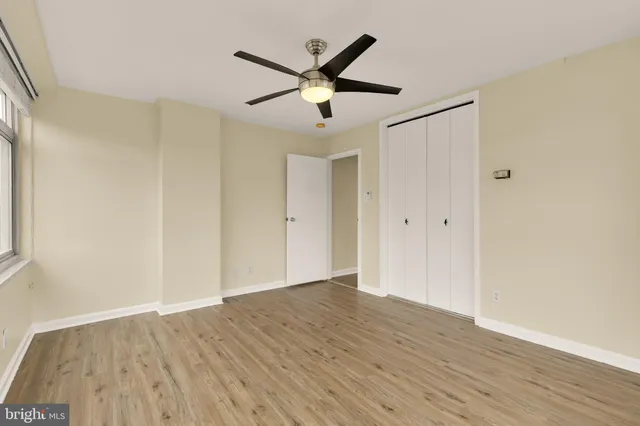 a view of an empty room with wooden floor