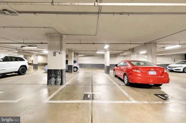a view of parking garage with cars parked