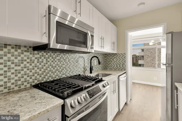 a kitchen with a stove and a microwave