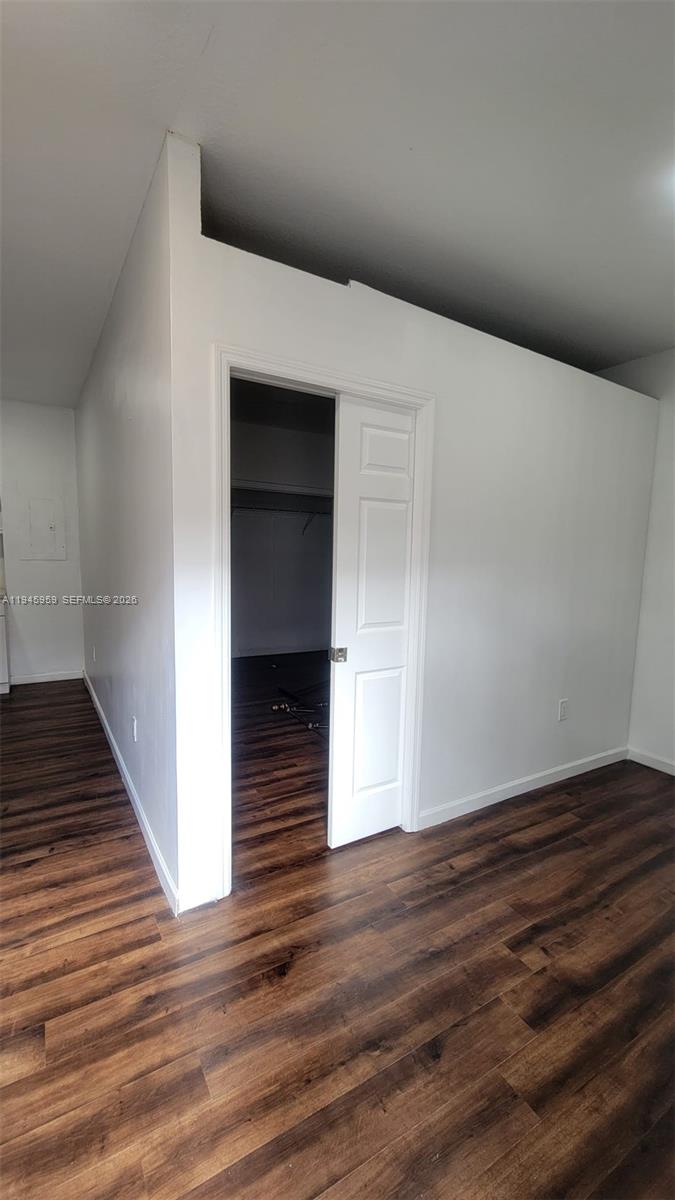 10172 Southwest 159th Avenue Miami, FL 33196 - Photo 4 of 10 a view of an empty room with wooden floor