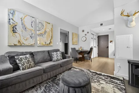 a living room with furniture and wooden floor