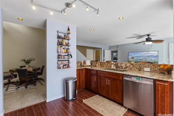 a kitchen with stainless steel appliances granite countertop a sink and cabinets