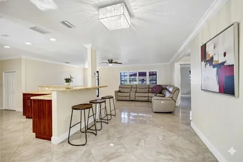 a living room with furniture and view of kitchen