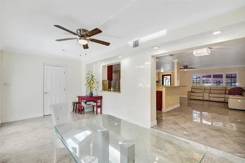 a view of a livingroom with furniture and a ceiling fan