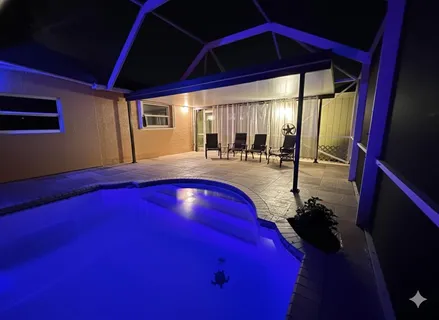 a view of backyard with swimming pool and porch