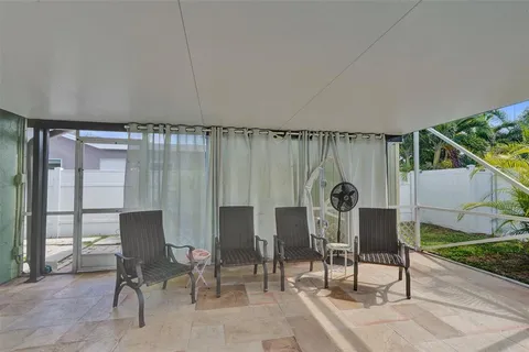 a view of a chairs and table in a patio