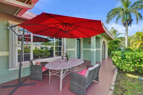 a view of a house with backyard and sitting area
