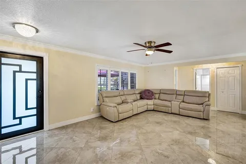 a living room with furniture and a ceiling fan