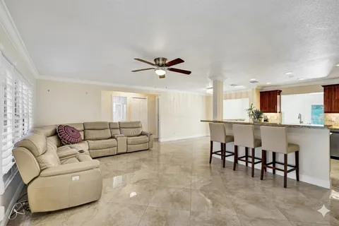 a living room with furniture and kitchen view