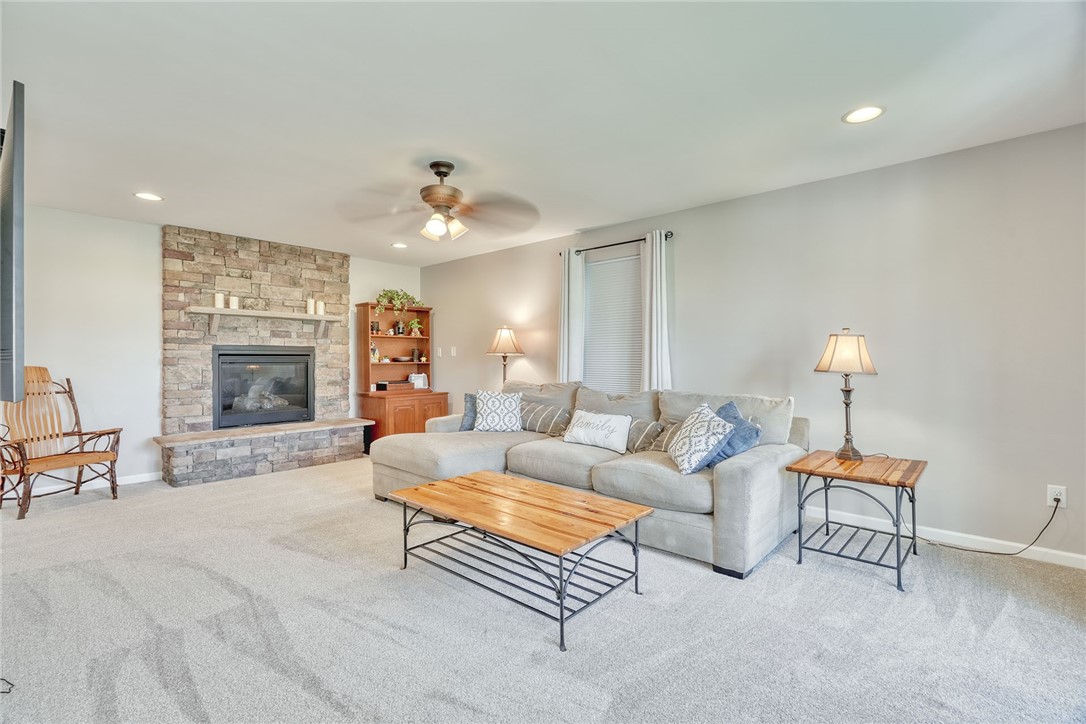 32 Ashlyn Rise Penfield, NY 14450 - Photo 9 of 50 Living room with gas fireplace and new carpeting.