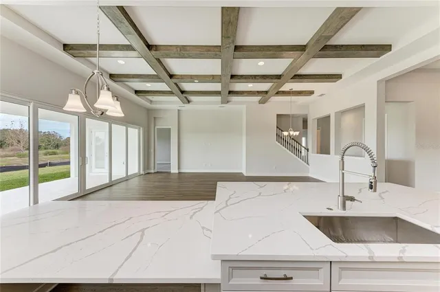 a view of a kitchen with a sink and chandelier
