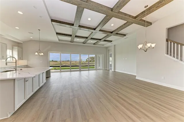a view of a kitchen with a sink and wooden floor