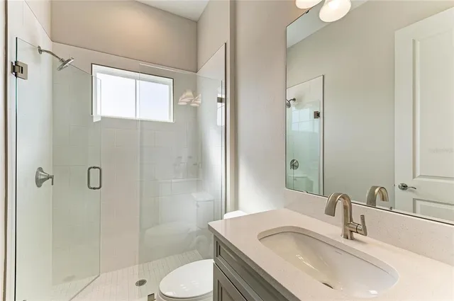 a bathroom with a sink toilet and shower