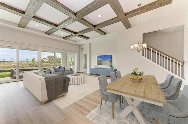 a living room with furniture wooden floor and a large window