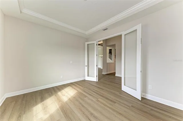 a view of an empty room and wooden floor