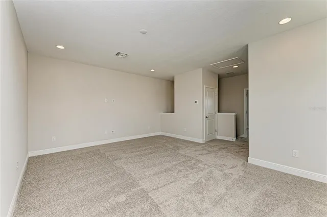 an empty room with white walls and windows