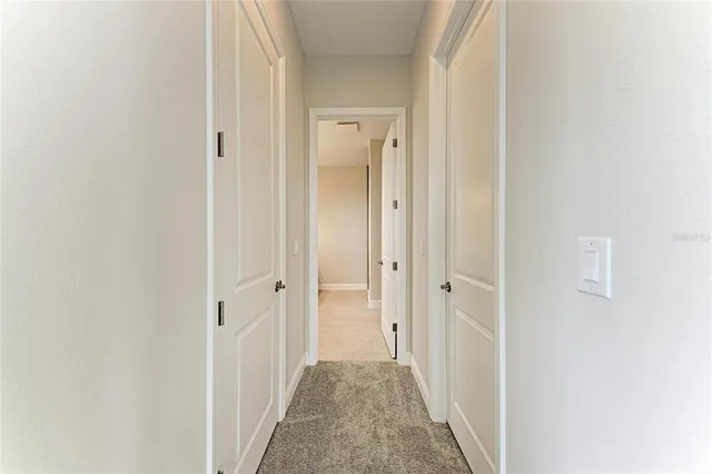 a view of a hallway with a wooden door